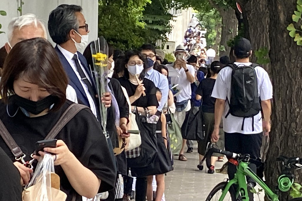 Sorban állnak az emberek a meggyilkolt japán miniszterelnök, Abe Sindzó temetése előtt.